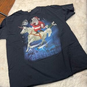 Cat Santa Claus with cat elf  on a unicorn flying over mountain, BELIEVE tee